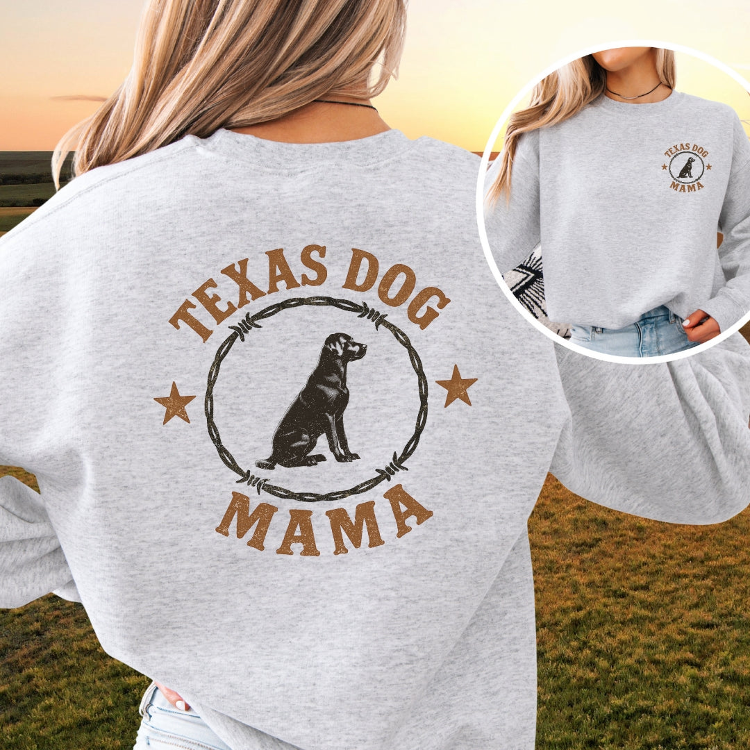 Woman wearing heather gray Texas Dog Mama Labrador sweatshirt with rustic barbed wire design, western style, sunset background.